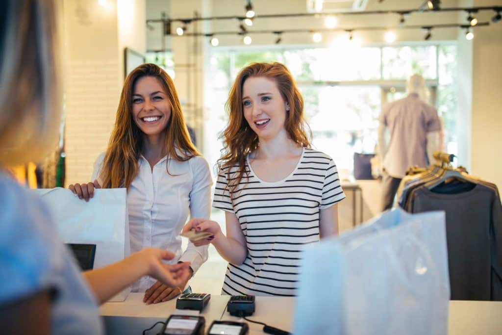 mom and daughter shopping using a regular checking account